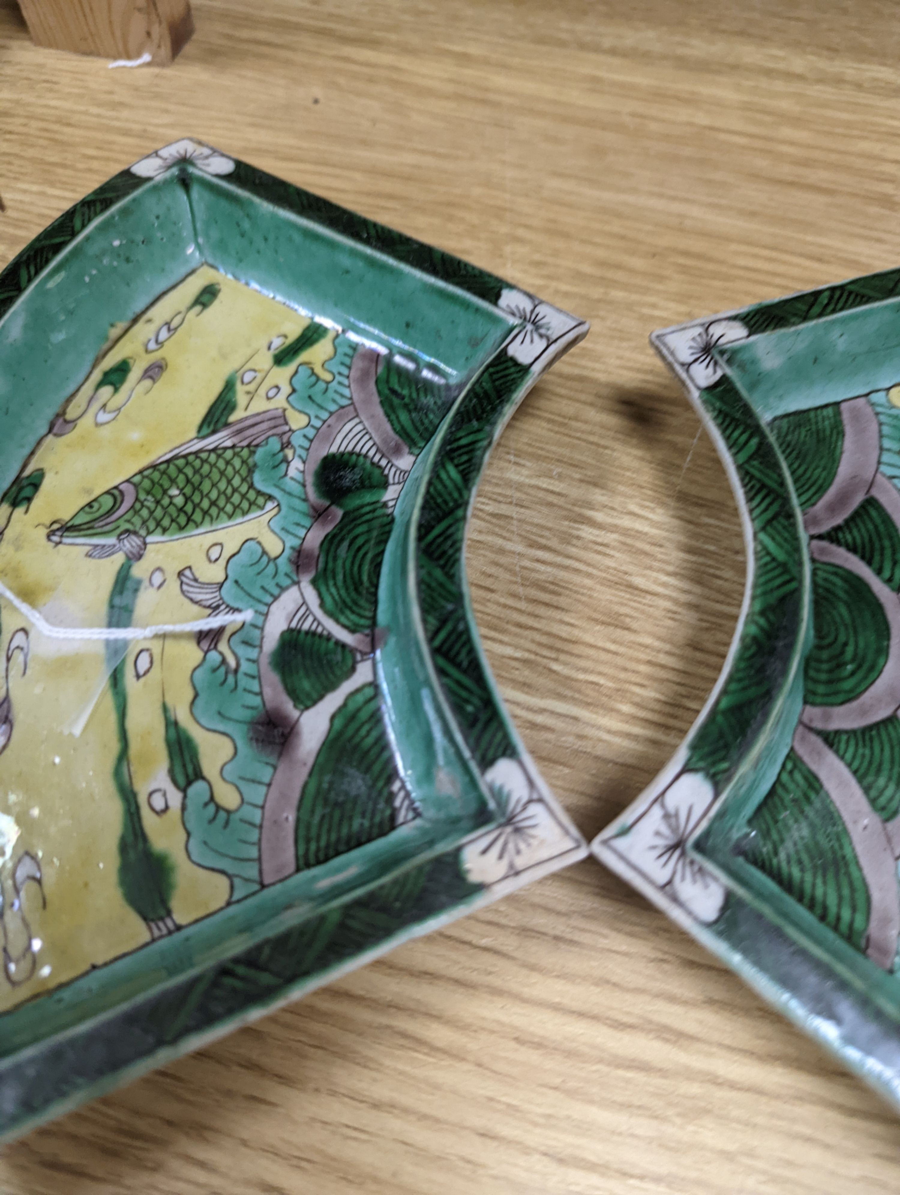 A pair of Chinese famille verte biscuit fan-shaped sweetmeat dishes, Kangxi, 20 cms wide.